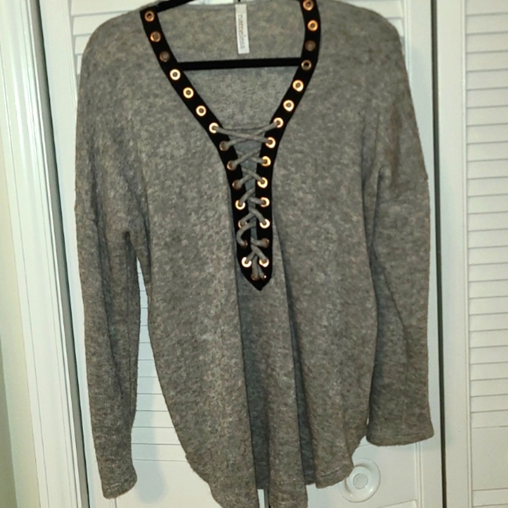 Elegant Grey long-sleeved sweater with lace up detail in the front